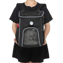 Foldable 2-in-1 pet bike bag and backpack in black, worn by a person, front view