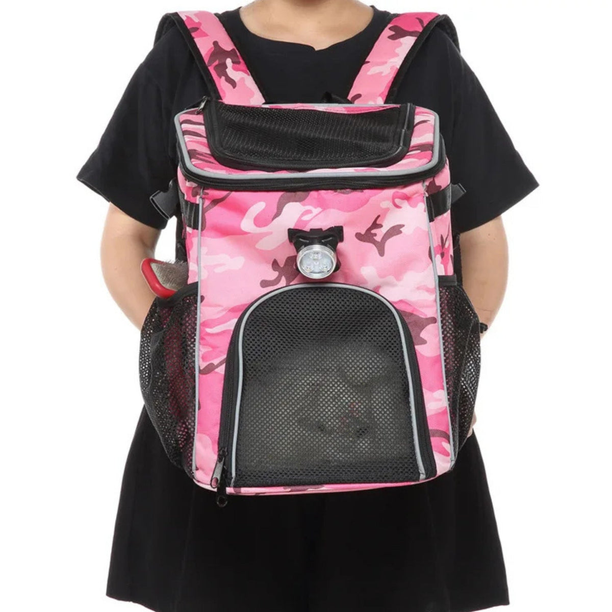 Foldable 2-in-1 pet bike bag and backpack in pink, worn by a person, front view