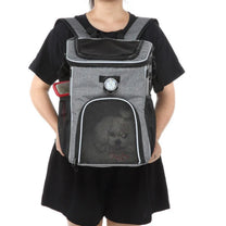 Foldable 2-in-1 pet bike bag and backpack in grey, worn by a person, front view
