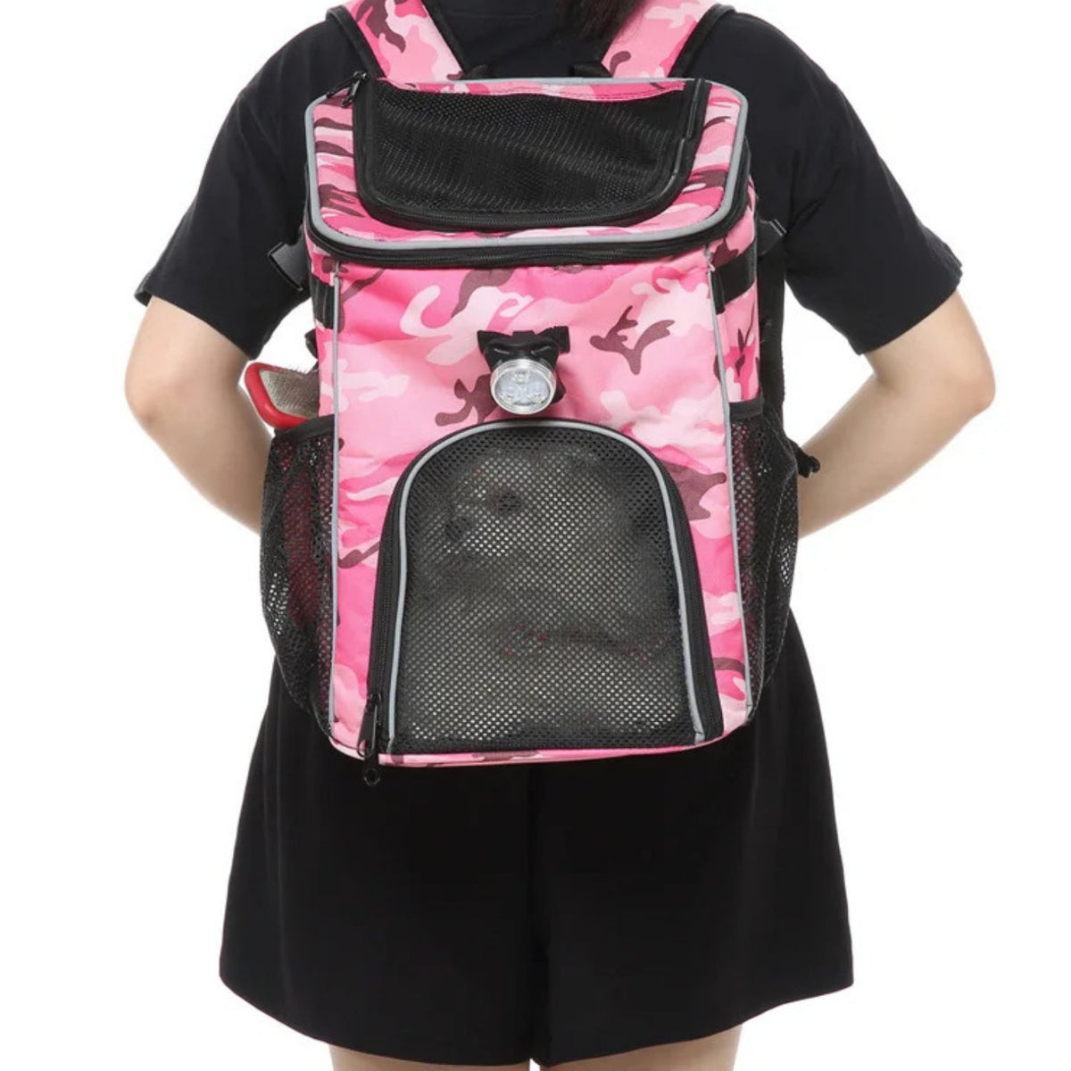 Foldable 2-in-1 pet bike bag and backpack in pink, worn by a person