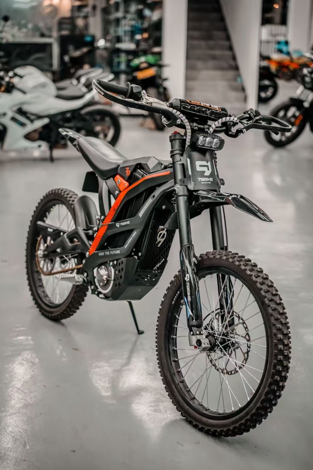 79BIKE Falcon Pro electric dirt bike, front three-quarter view indoors
