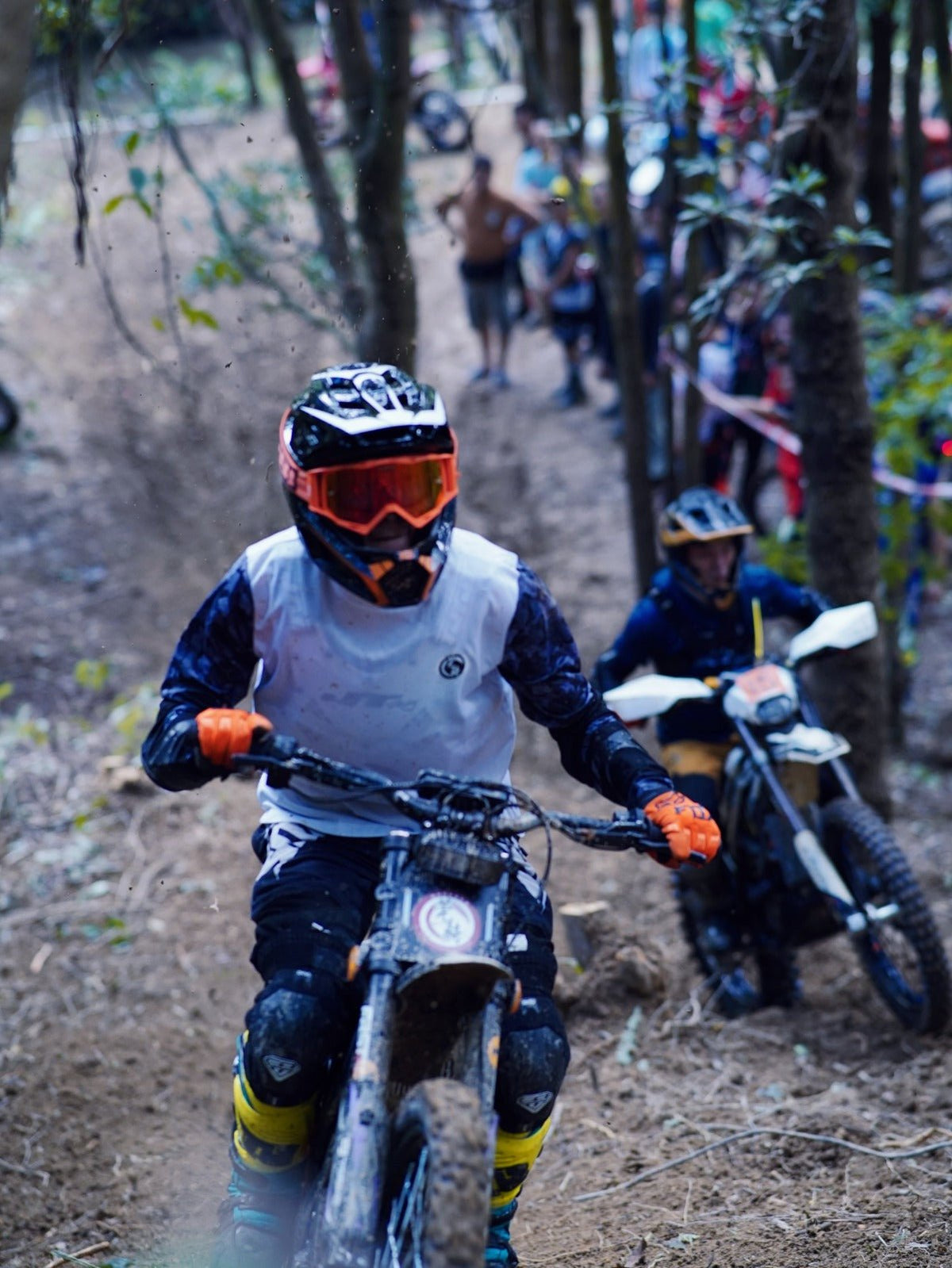 Rider taking the 79BIKE Falcon Pro electric dirt bike off-road in the forest
