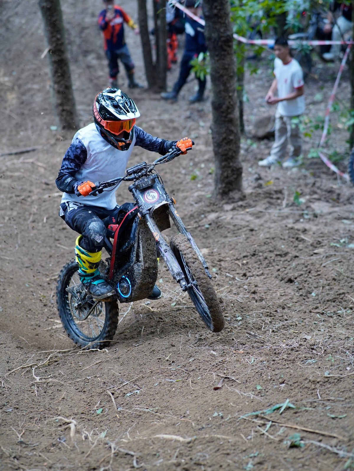 Rider taking the 79BIKE Falcon Pro electric dirt bike off-road in the forest
