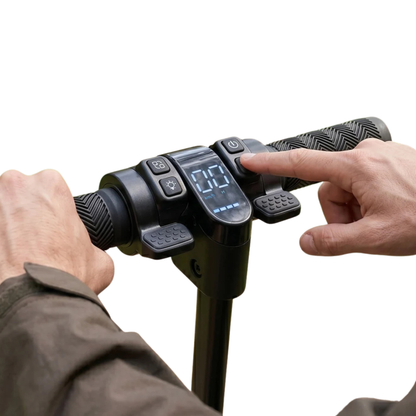 Close-up of handlebar with display and buttons, with a finger pressing a button