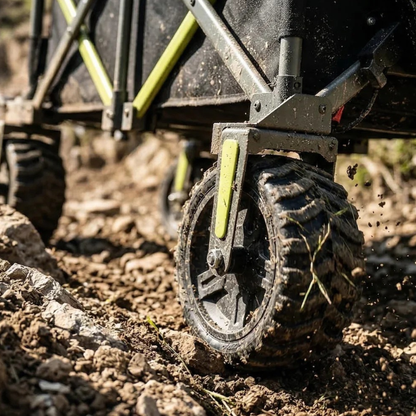 Close-up of a muddy chunky-tread wheel and lime green frame detail on the DYU CampX on dirt ground