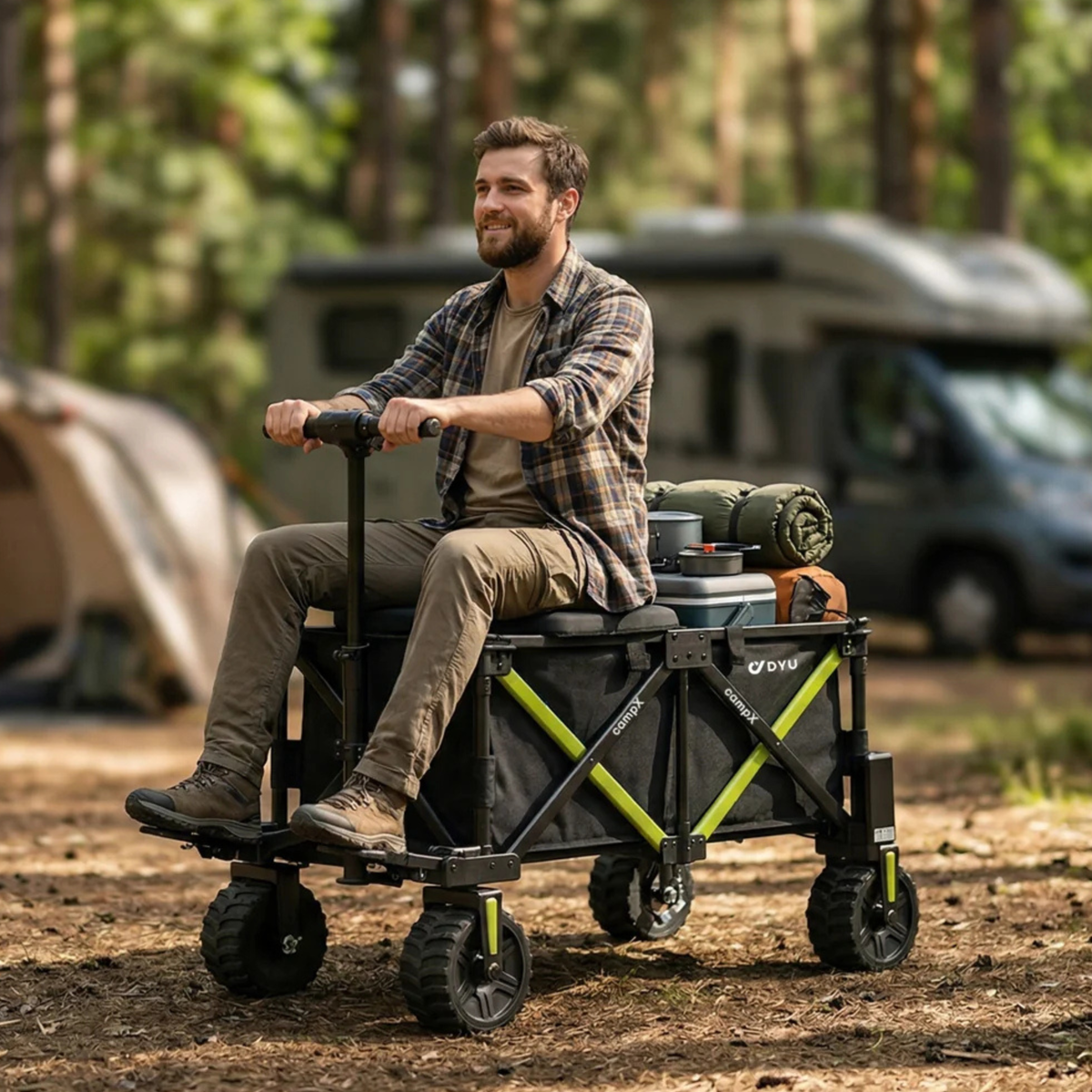 Man sitting on the DYU CampX with luggage at a woodland campsite, motorhome and tent in the background
