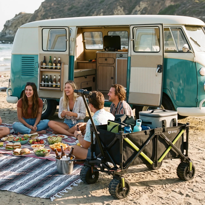 DYU CampX on a beach with bags and bottles in the wagon, in front of a van and a picnic