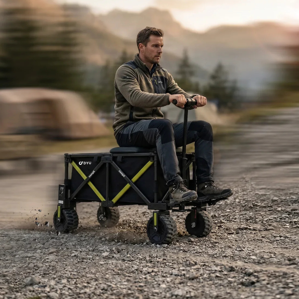 DYU CampX on gravel with a man sitting on the wagon and a blurred background