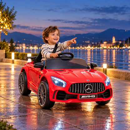 Child driving the Mercedes AMG GT electric ride-on car for kids by the sea