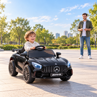 Child driving the Mercedes AMG GT electric ride-on car for kids with an adult nearby in black