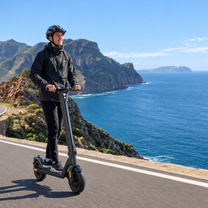 Man riding the HX D01 electric scooter in the mountains