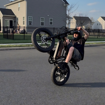 Man riding the TST R002 Plus fat-tyre e-bike in black on a street