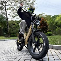 Man riding the TST R7 fat-tyre e-bike in black on a footpath