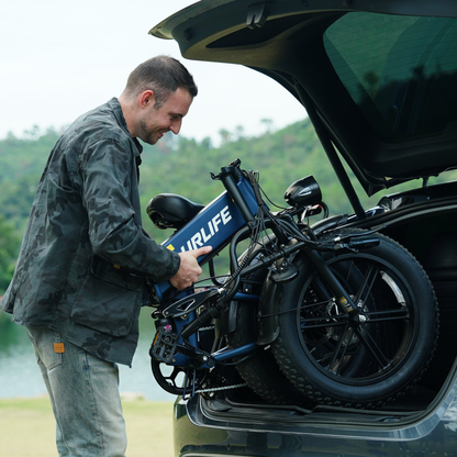 Man lifting a folded URLIFE T5 into a car boot