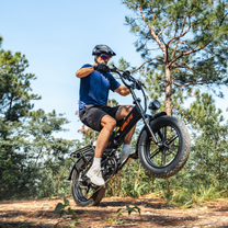 URLIFE T5 with rider on a forest trail, front wheel lifted off the ground