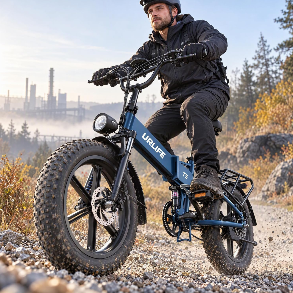 Blue URLIFE T5 with rider on gravel, industrial buildings in the background
