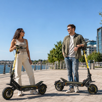 Woman and man stand next to a Wheely - H7 each on a quay