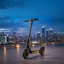 Wheely J04 electric scooter, front three-quarter view in an evening setting