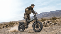 Person riding the APEFOX RH20 folding fat-tyre e-bike on a grassy field
