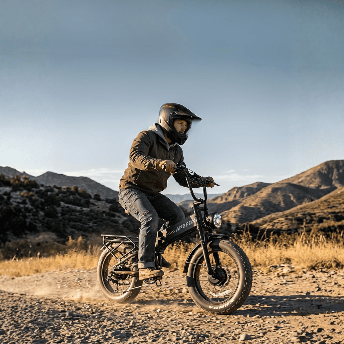 Rider taking the APEFOX RH20 folding fat-tyre e-bike off-road