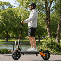 Man standing with the BOYUEDA M2 electric scooter in a park