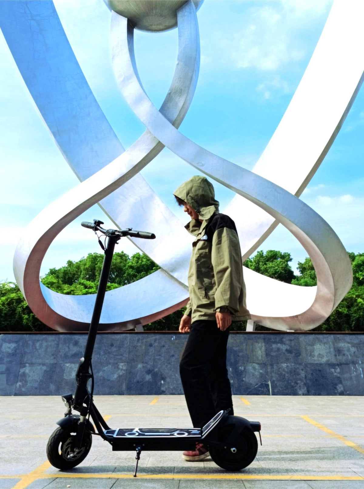 Man riding the DriveTron DT01 electric scooter in the city