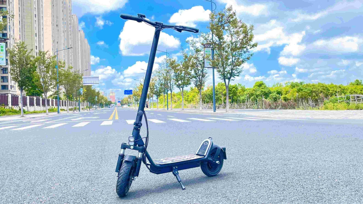 DriveTron DT01 electric scooter, front three-quarter view in the city