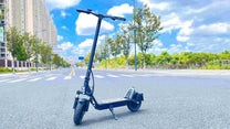 DriveTron DT01 electric scooter, front three-quarter view in the city