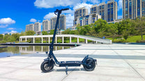 DriveTron DT01 electric scooter seen from the side by a lake