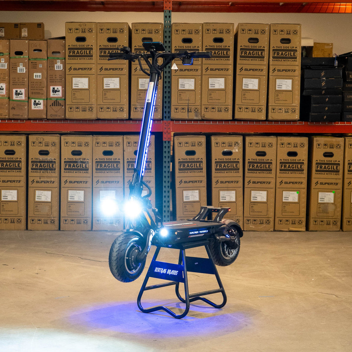 DUALTRON THUNDER 3 electric scooter, front three-quarter view with the lights on indoors