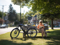 Person sitting next to the Duotts C29 Max e-bike in a park
