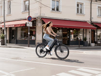 Woman riding the Duotts C29 Max e-bike on a road