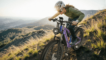 Man riding the Duotts E26 fat-tyre e-bike on a grassy field