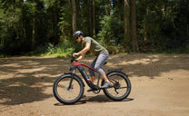 Man riding the Duotts F26 Lite fat-tyre e-bike on a footpath