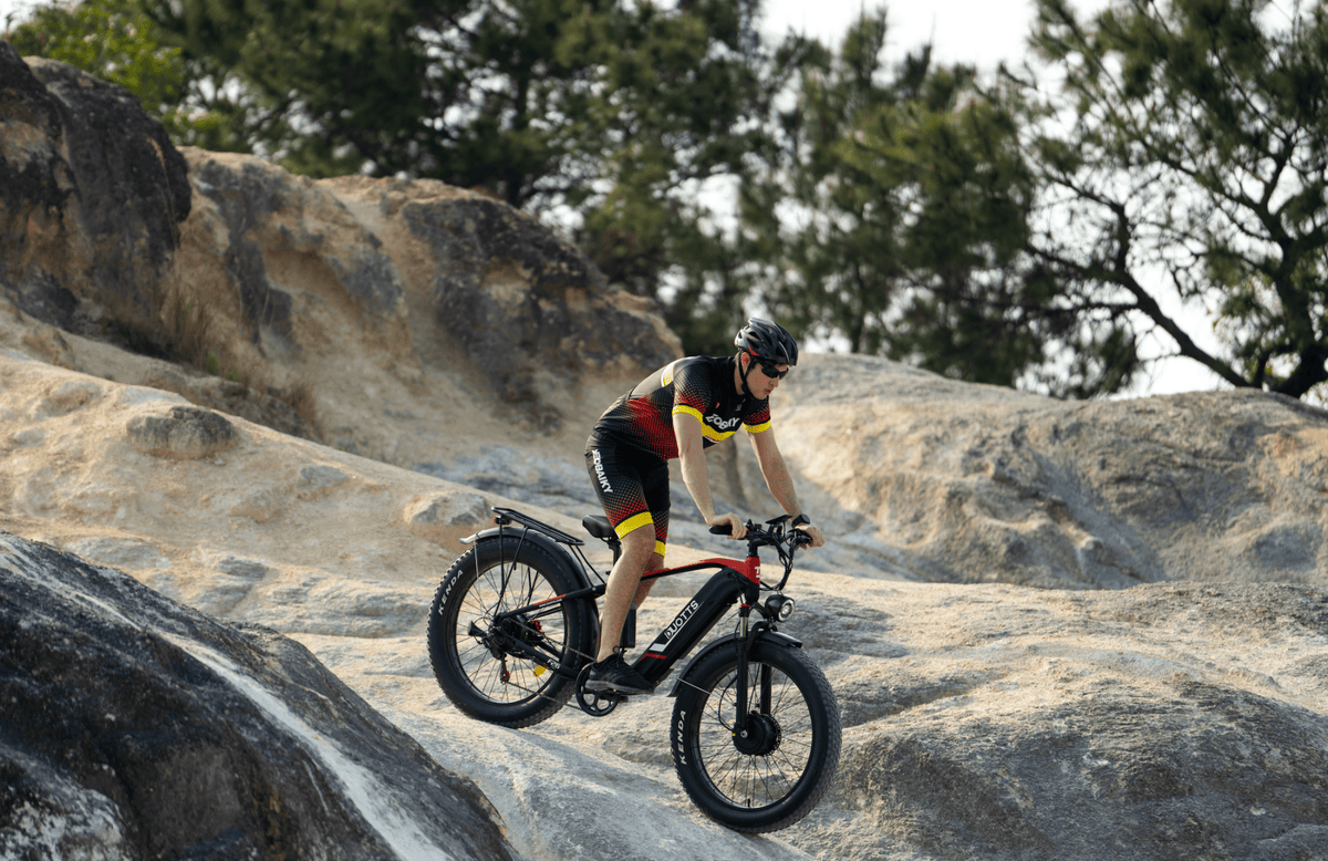 Rider taking the Duotts F26 fat-tyre e-bike off-road