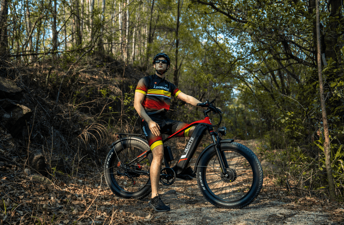 Rider taking the Duotts F26 fat-tyre e-bike off-road in the forest