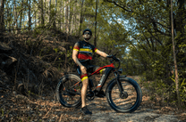 Rider taking the Duotts F26 fat-tyre e-bike off-road in the forest