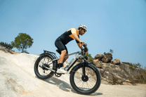 Rider taking the Duotts F26 fat-tyre e-bike off-road