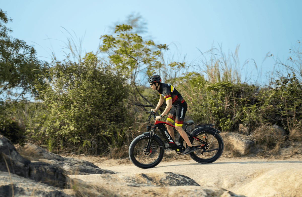 Rider taking the Duotts F26 fat-tyre e-bike off-road