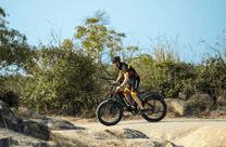 Rider taking the Duotts F26 fat-tyre e-bike off-road