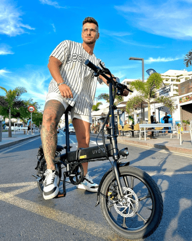 Man standing with the DYU A1F Pro folding e-bike in the city