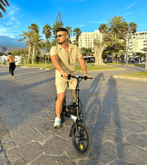 Man standing with the DYU A1F Pro folding e-bike in the city