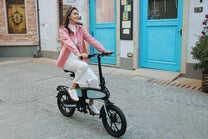Woman riding the DYU C2 folding e-bike in the city