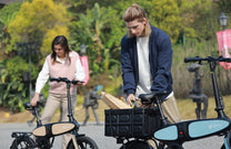 Two riders with the DYU C2 folding e-bike in the city