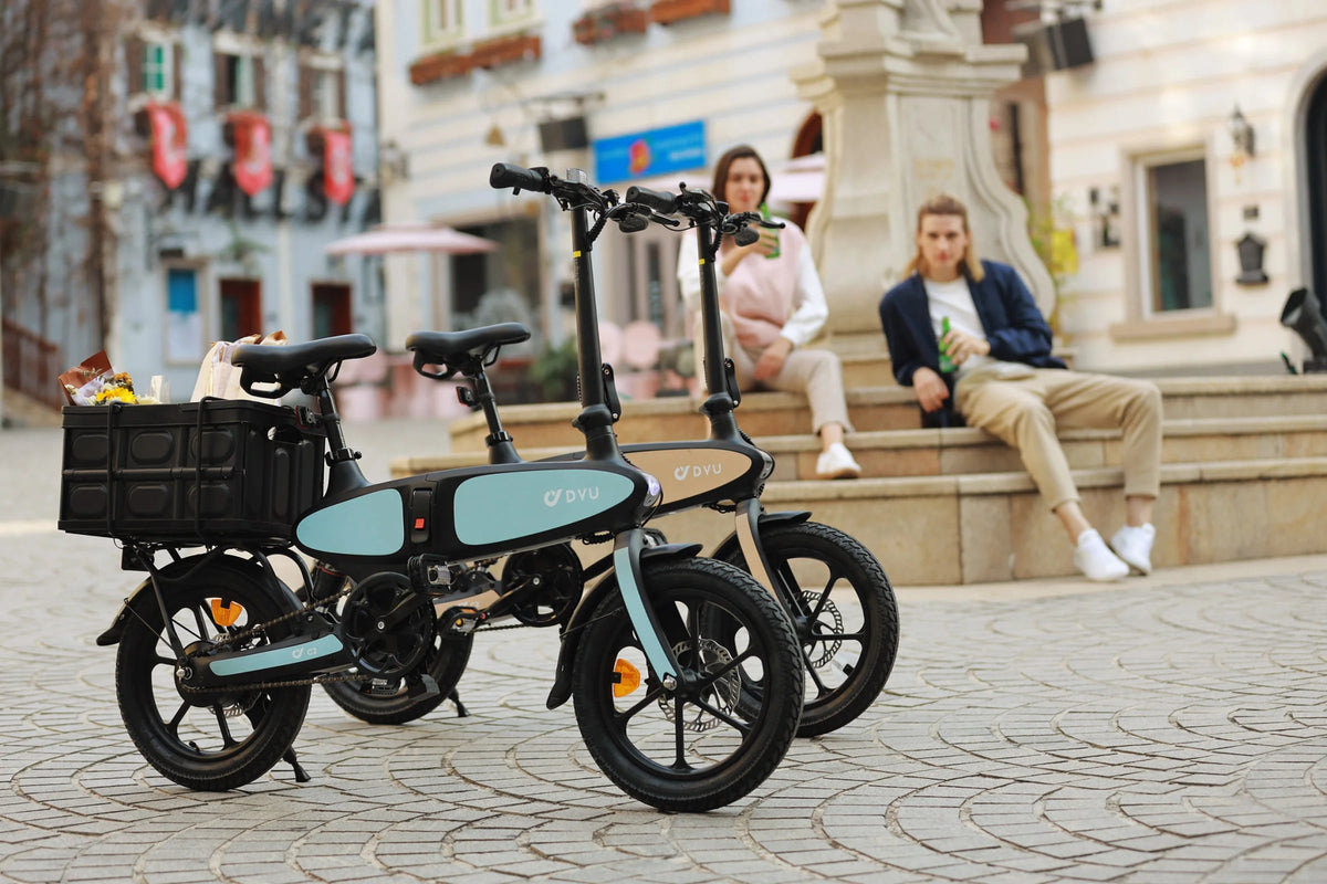 Two riders with the DYU C2 folding e-bike in the city