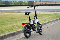 DYU C2 folding e-bike, rear three-quarter view on a footpath