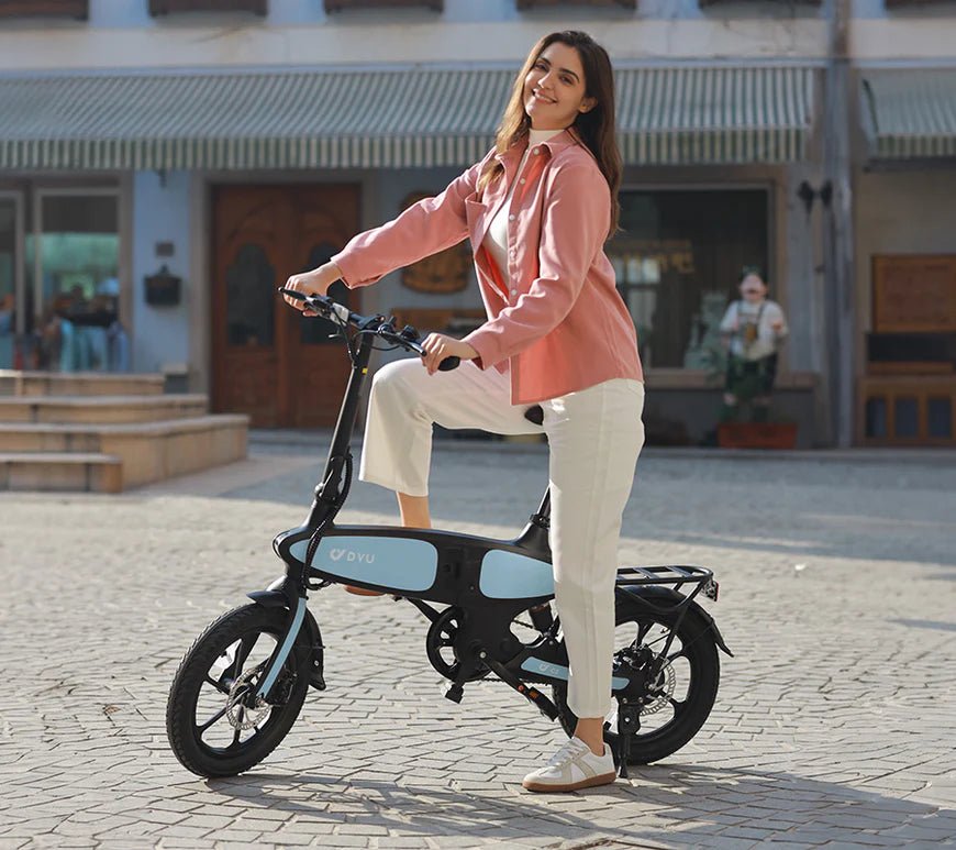 Woman standing with the DYU C2 folding e-bike in the city