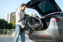 Folded DYU C9 folding e-bike in a car boot