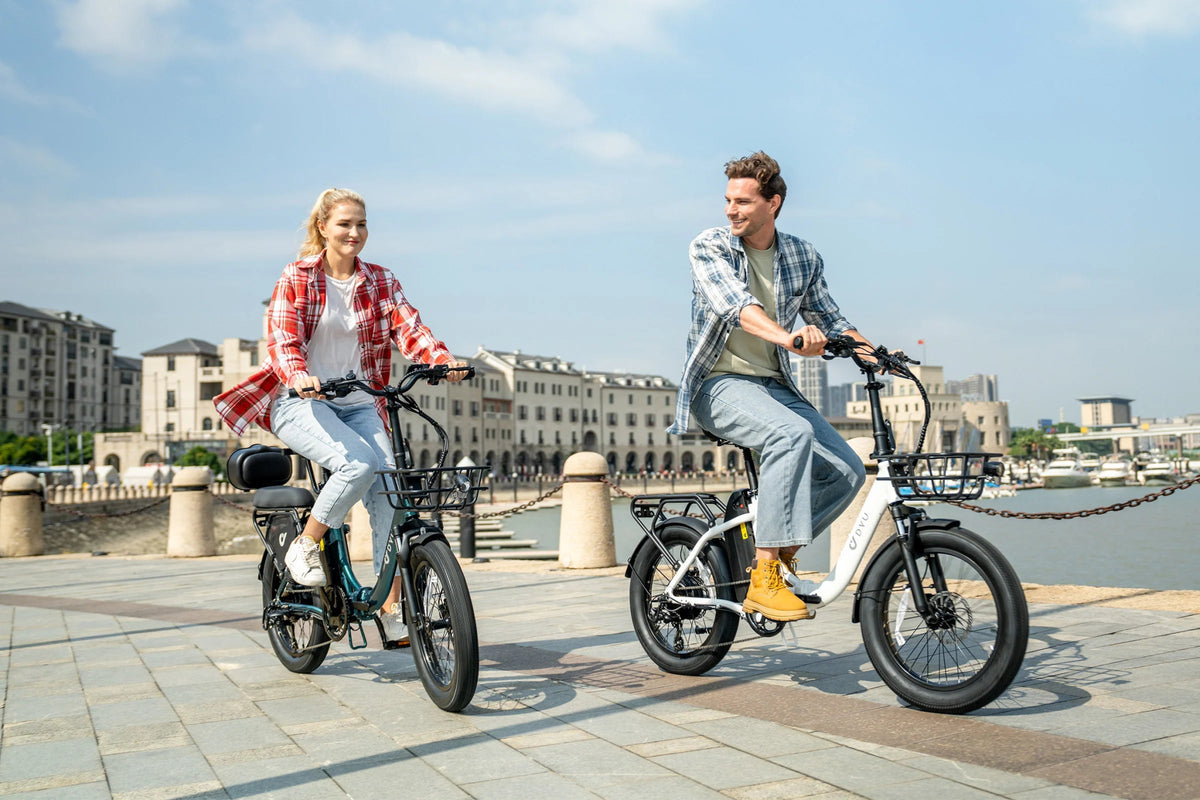 Two riders with the DYU C9 folding e-bike in the city