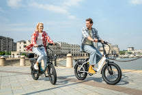 Two riders with the DYU C9 folding e-bike in the city